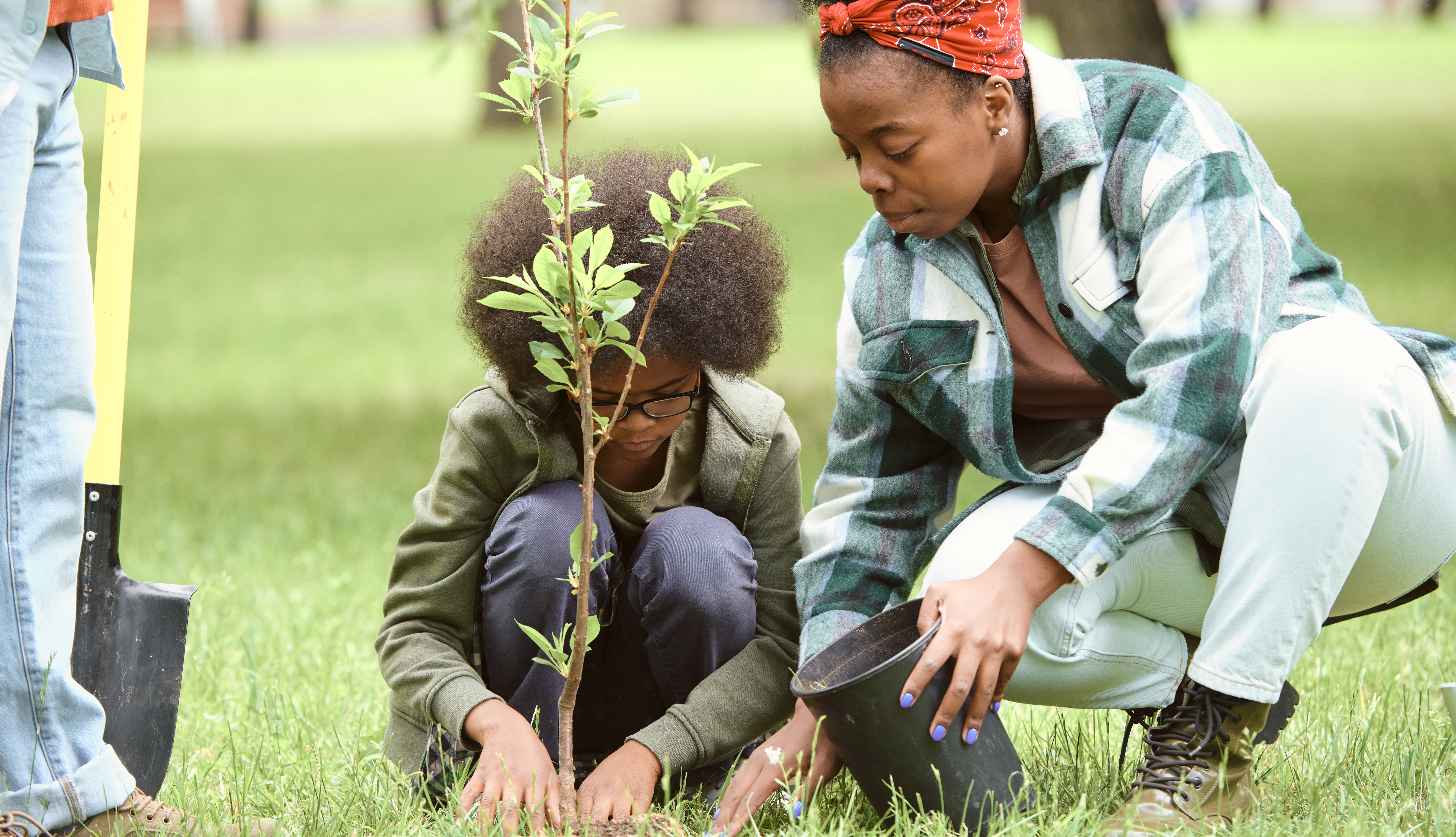 woman and child planting tree